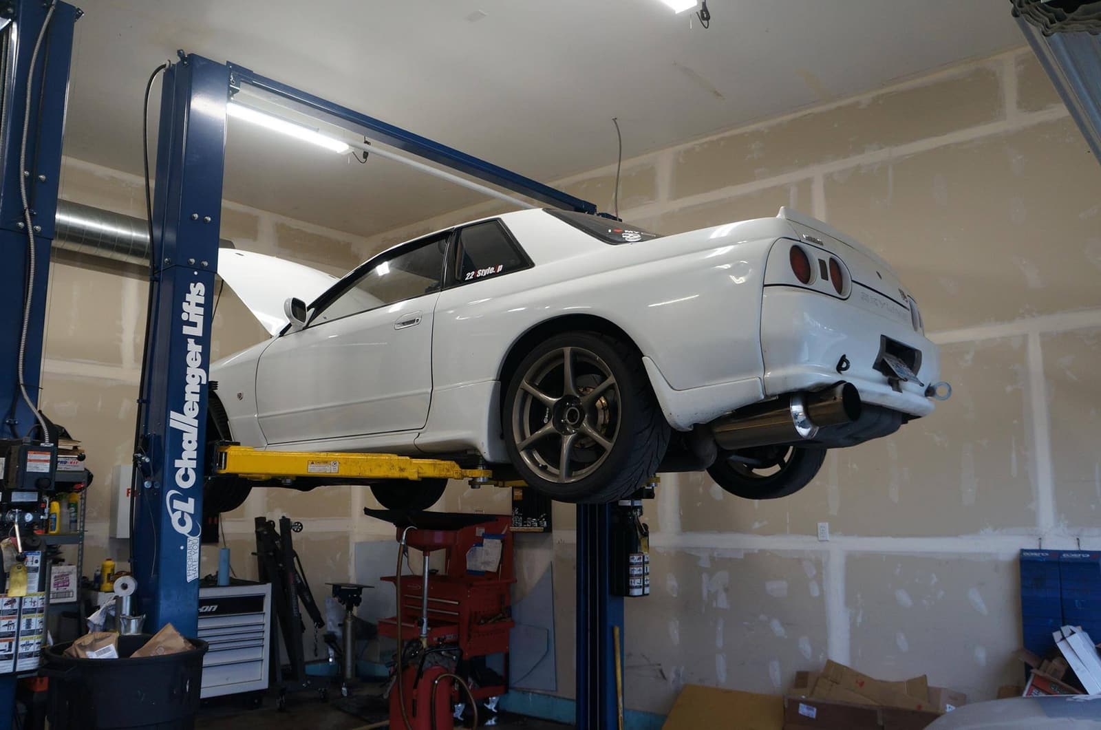 A car up on the lift in one of our bays