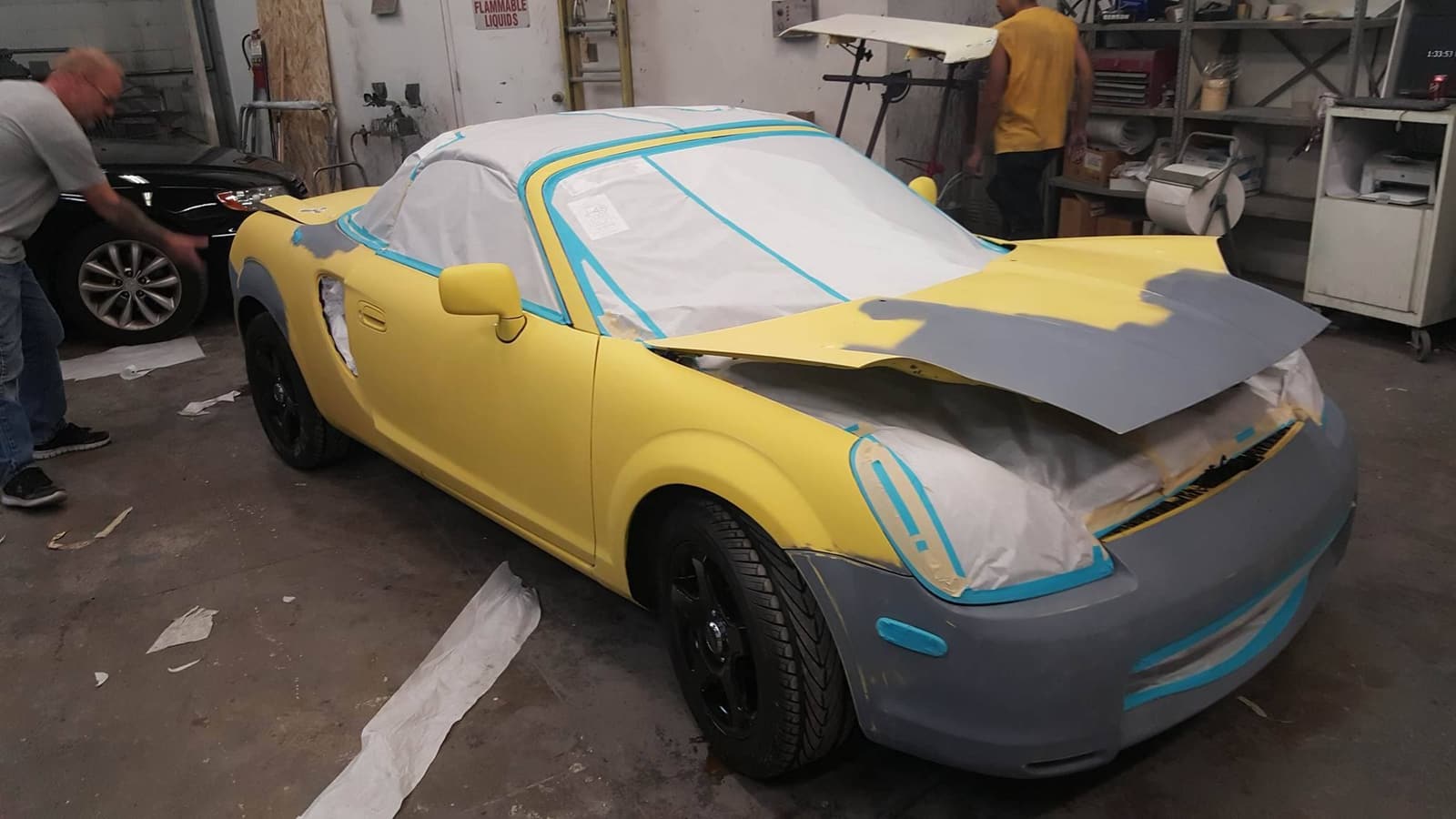 A project car taped up for bodywork in our shop